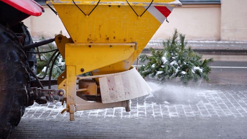 A truck spraying deicing salt on a street.